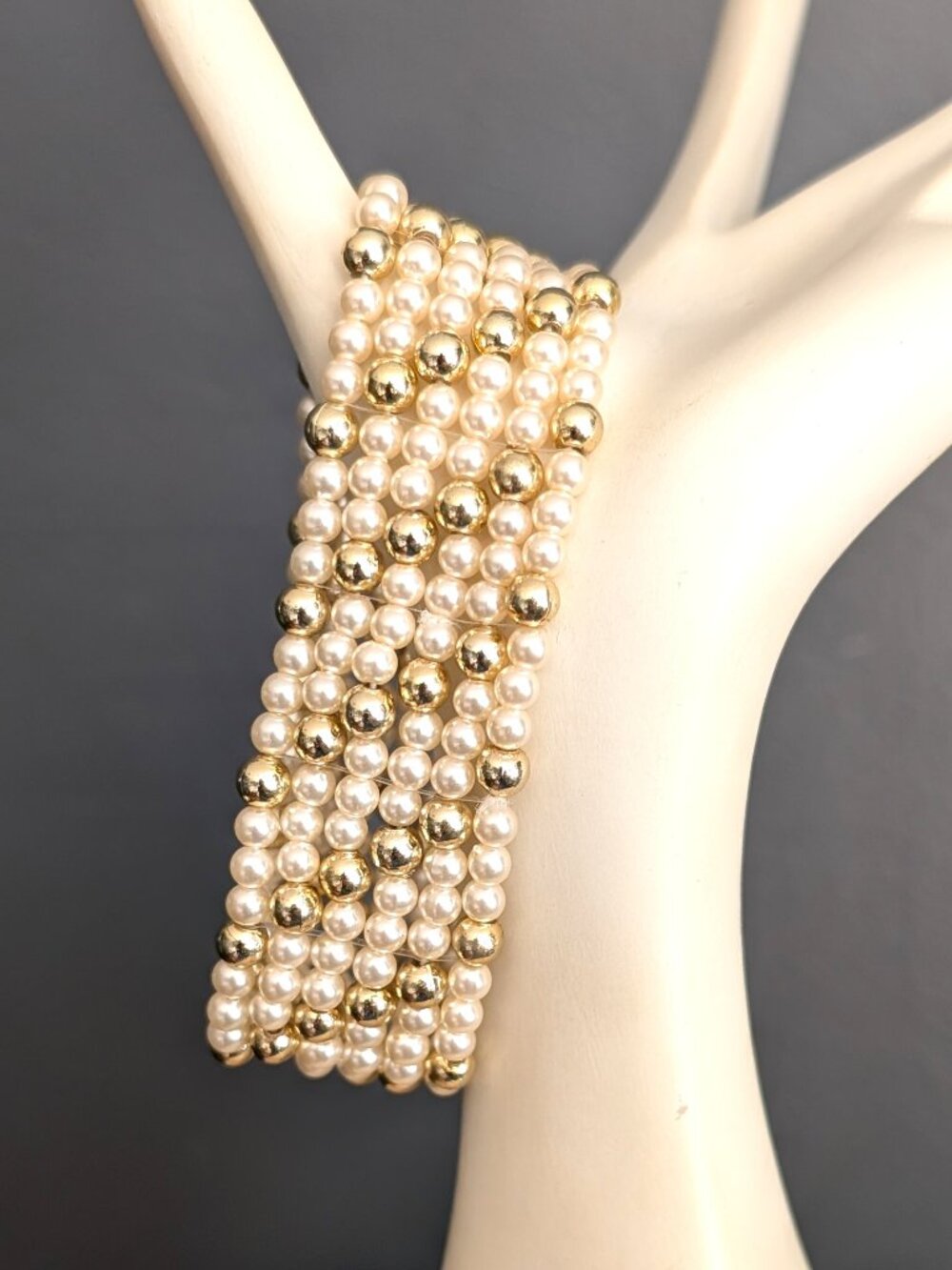Faux cream pearl and gold tone beaded stretch bracelet